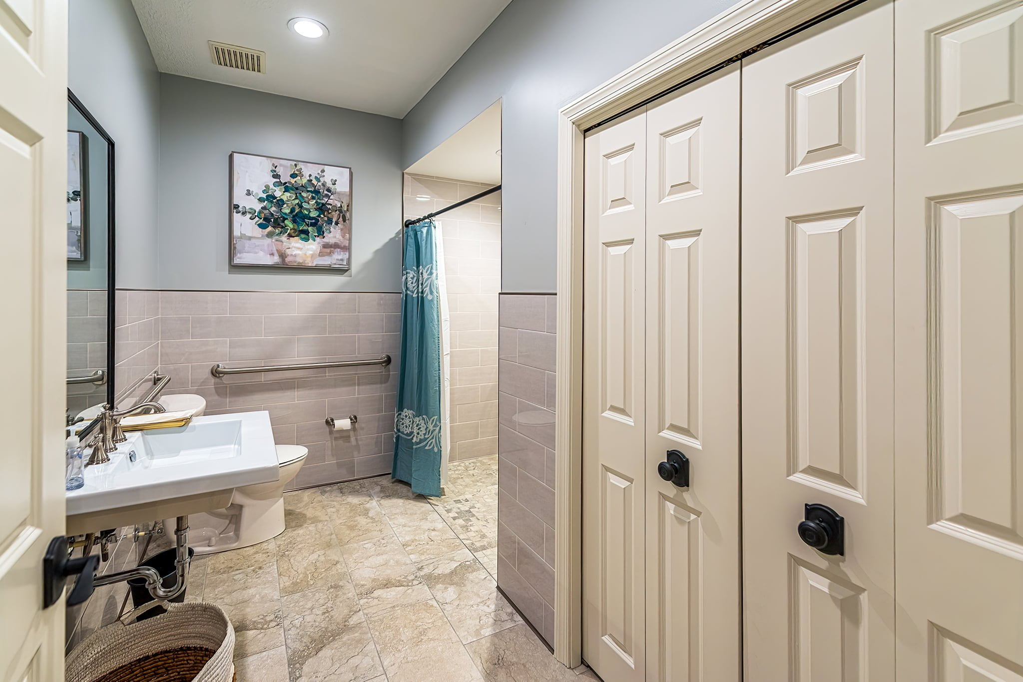 A spacious bathroom with a walk-in shower, designed with calm colors and environment for great accessibility at Camella Living.